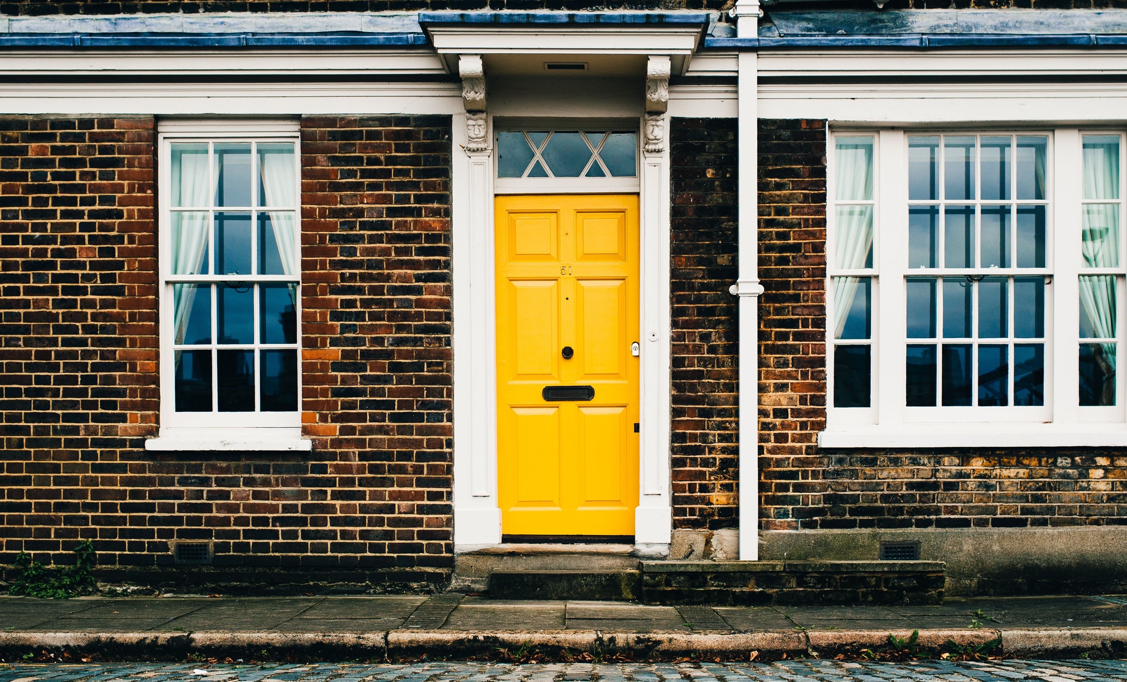 yellow-door-on-brick-home_4460x4460-212117-edited