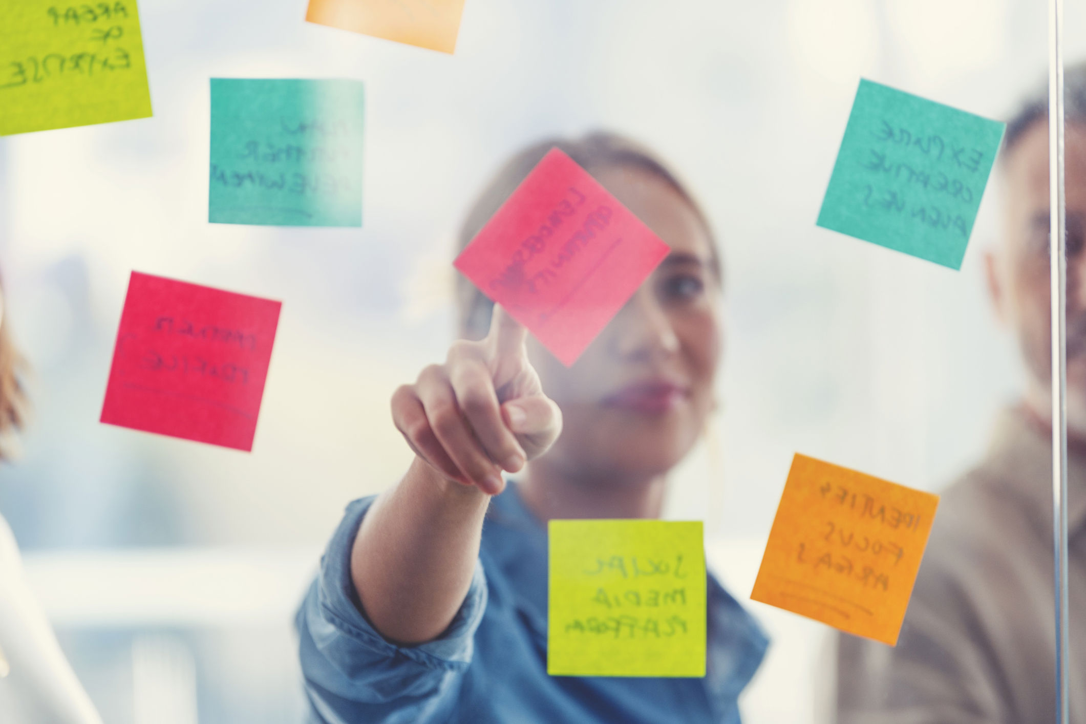 person brainstorming with sticky notes